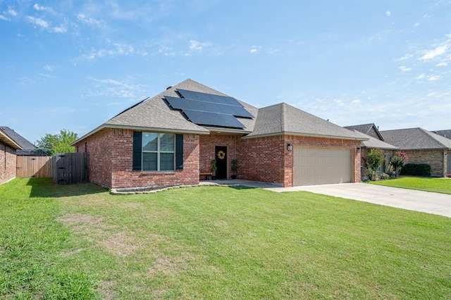 321 SW 147th St, Oklahoma City, OK 73160 - view of front of home featuring brick siding, roof with shingles, a garage, and roof mounted solar panels
