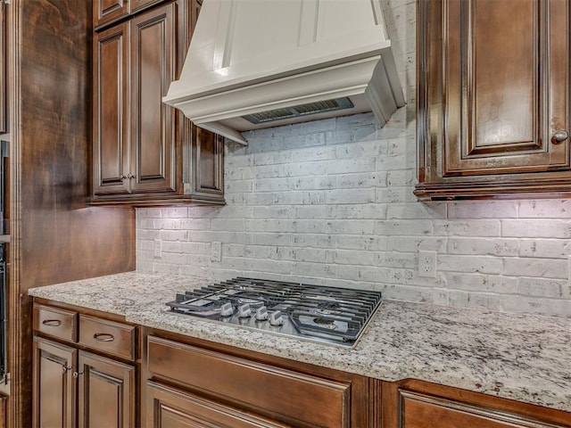 1470 Auburn Cir, Piedmont, OK 73078 - kitchen featuring custom range hood, stainless steel gas stovetop, light stone counters, and tasteful backsplash