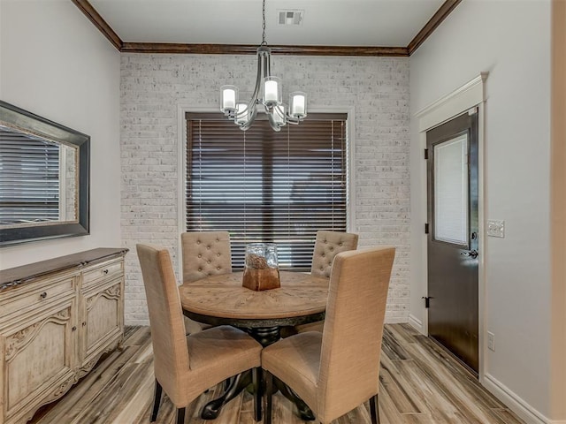 1470 Auburn Cir, Piedmont, OK 73078 - dining area with a chandelier, ornamental molding, light wood finished floors, and brick wall