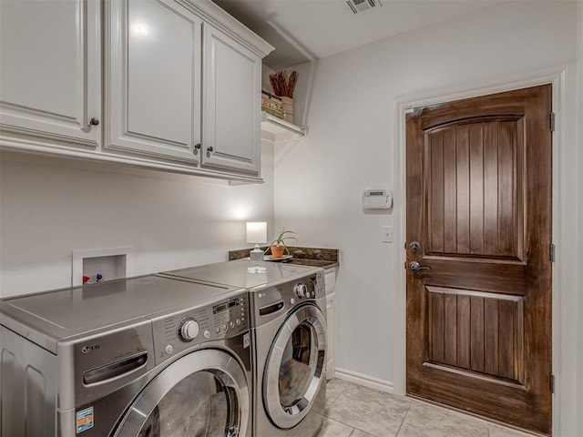 1470 Auburn Cir, Piedmont, OK 73078 - laundry area with cabinet space, washer and clothes dryer, and light tile patterned flooring