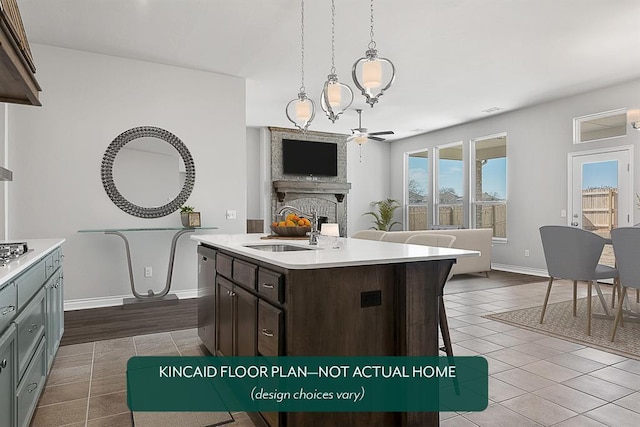 1416 SW 160th St, Moore, OK 73170 - kitchen with open floor plan, appliances with stainless steel finishes, dark brown cabinets, a fireplace, and light countertops