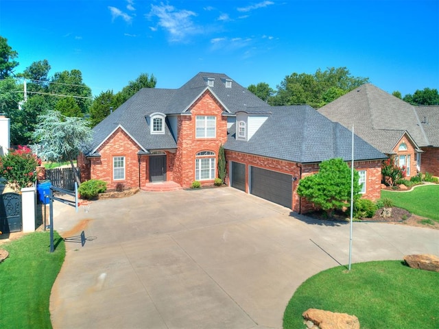 1008 Bentbrook Pl, Norman, OK 73072 - traditional home featuring concrete driveway, an attached garage, brick siding, and roof with shingles
