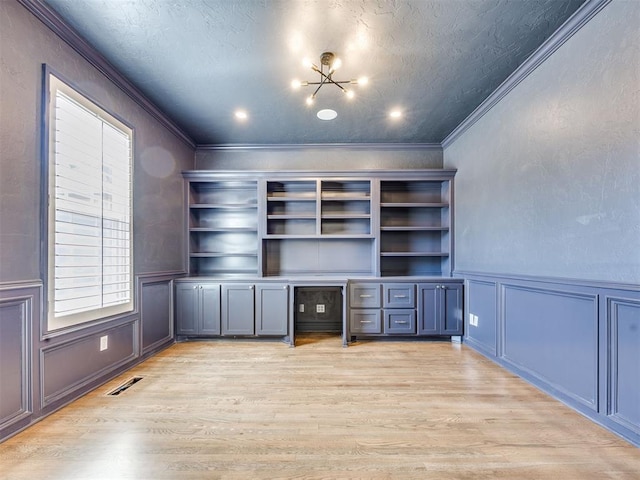 1008 Bentbrook Pl, Norman, OK 73072 - unfurnished office featuring a decorative wall, light wood-style flooring, ornamental molding, a textured ceiling, and a wainscoted wall