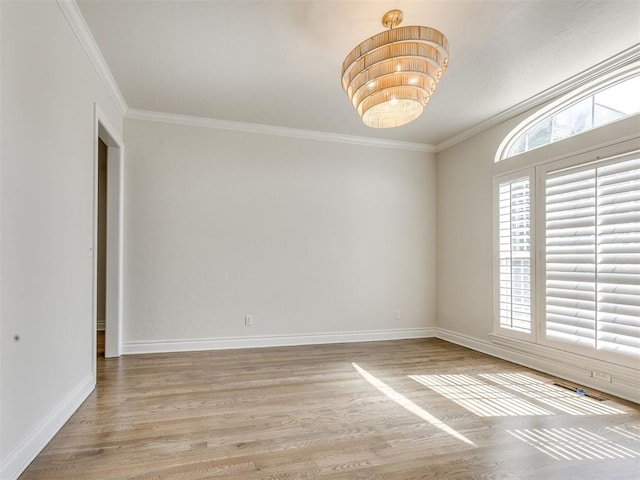 1008 Bentbrook Pl, Norman, OK 73072 - empty room featuring ornamental molding, wood finished floors, and a chandelier