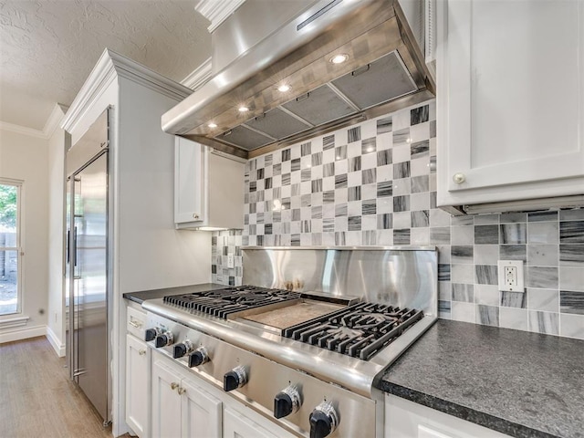 1008 Bentbrook Pl, Norman, OK 73072 - kitchen featuring premium range hood, appliances with stainless steel finishes, ornamental molding, dark countertops, and tasteful backsplash