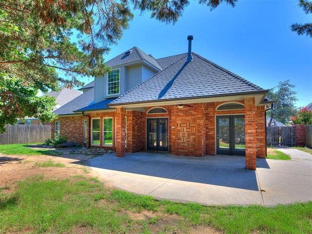 1008 Bentbrook Pl, Norman, OK 73072 - traditional home featuring french doors, roof with shingles, a patio area, and brick siding