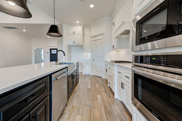 1632 NE 35th St, Moore, OK 73160 - kitchen featuring appliances with stainless steel finishes, white cabinetry, light wood finished floors, pendant lighting, and recessed lighting