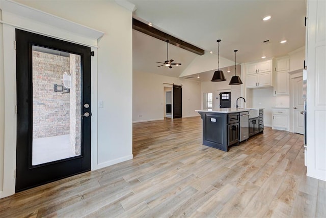 1632 NE 35th St, Moore, OK 73160 - kitchen with white cabinets, open floor plan, light countertops, decorative light fixtures, and a center island with sink