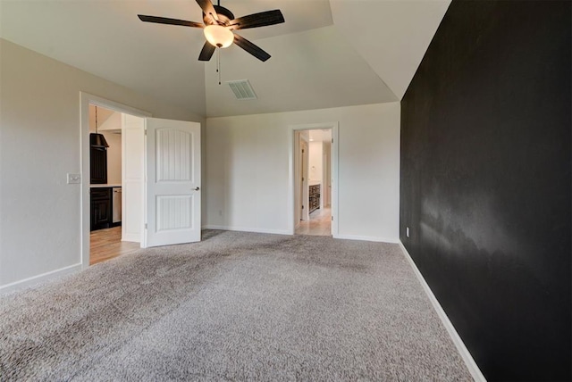 1632 NE 35th St, Moore, OK 73160 - unfurnished bedroom with light colored carpet, lofted ceiling, a walk in closet, and a ceiling fan