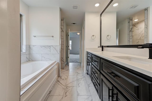 1632 NE 35th St, Moore, OK 73160 - full bathroom featuring marble look tile flooring, double vanity, a bath, recessed lighting, and a ceiling fan