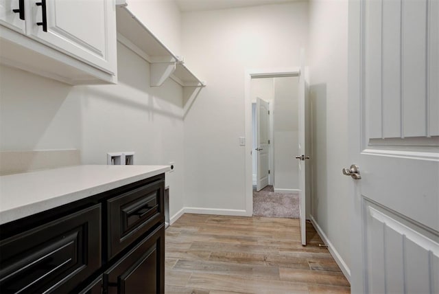 1632 NE 35th St, Moore, OK 73160 - laundry room with cabinet space, light wood finished floors, and hookup for a washing machine