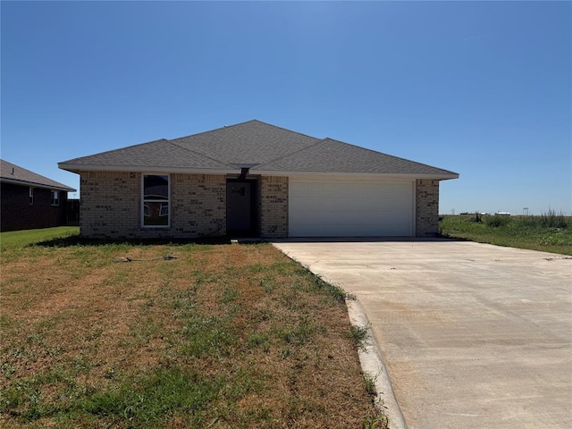 1808 Sommerset Pl, Altus, OK 73521 - view of front facade with brick siding, a garage, concrete driveway, and a front lawn