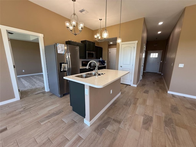 1808 Sommerset Pl, Altus, OK 73521 - kitchen featuring stainless steel appliances, a chandelier, light countertops, light wood-style flooring, and recessed lighting