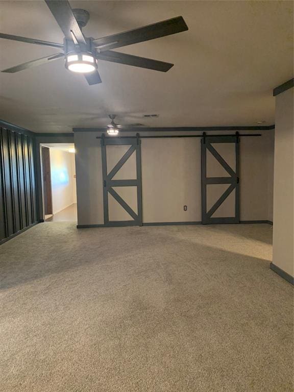 28153 County Street 2540Th, St, Fort Cobb, OK 73038 - spare room with a ceiling fan, a barn door, and light carpet