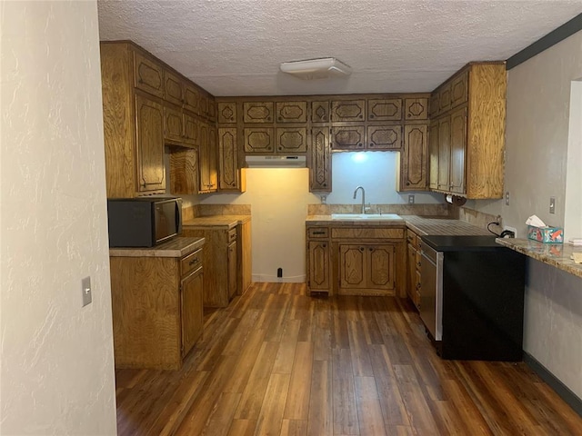 28153 County Street 2540Th, St, Fort Cobb, OK 73038 - kitchen with a textured ceiling, dark wood finished floors, brown cabinets, and under cabinet range hood