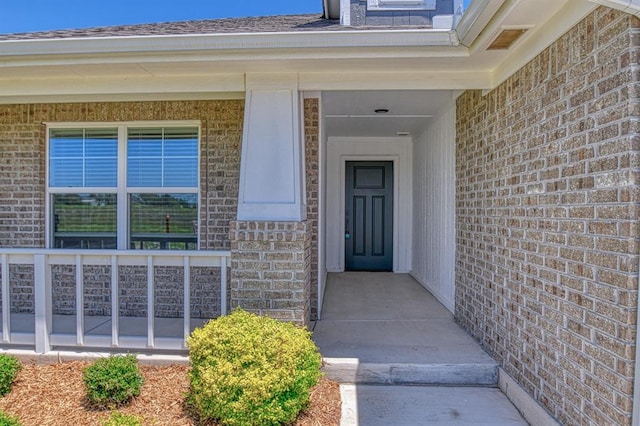 6413 SE 84th St, Oklahoma City, OK 73135 - doorway to property featuring brick siding and a porch