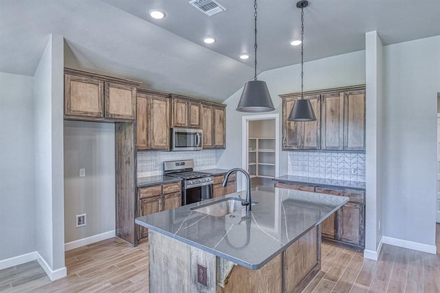 6413 SE 84th St, Oklahoma City, OK 73135 - kitchen featuring appliances with stainless steel finishes, dark countertops, light wood-type flooring, tasteful backsplash, and vaulted ceiling