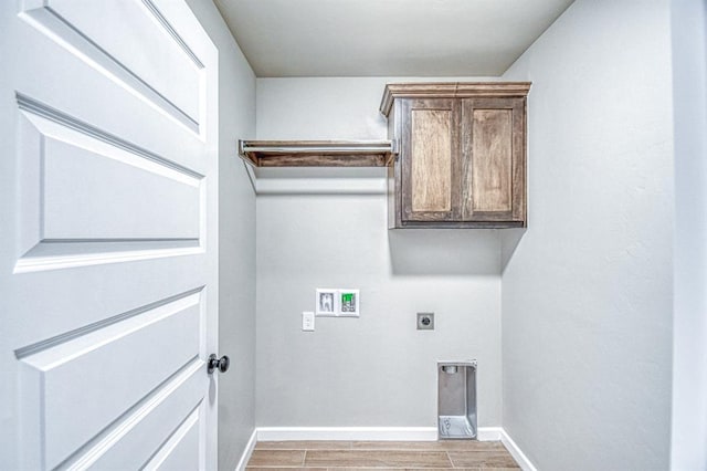 6413 SE 84th St, Oklahoma City, OK 73135 - laundry area with electric dryer hookup, washer hookup, light wood-style flooring, and cabinet space