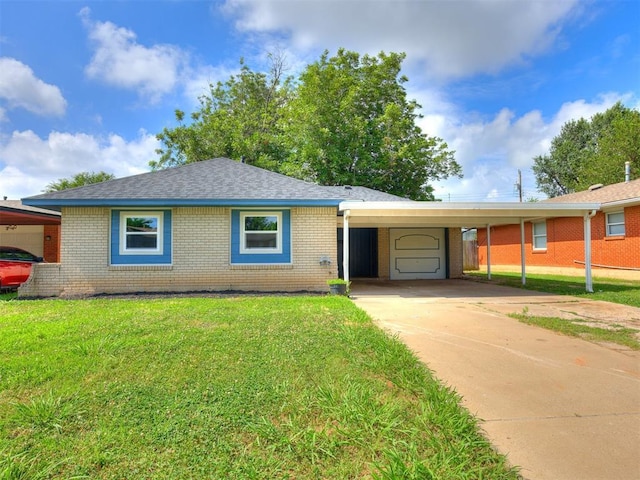 3044 S Madole Blvd, Oklahoma City, OK 73159 - ranch-style home featuring an attached carport, brick siding, a front yard, and driveway