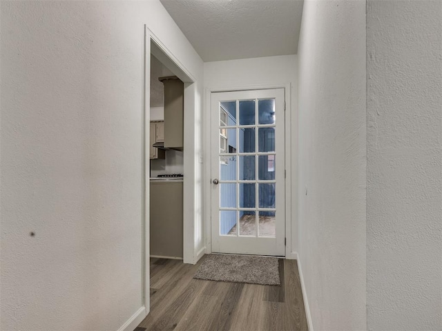 3044 S Madole Blvd, Oklahoma City, OK 73159 - doorway with wood finished floors and a textured wall
