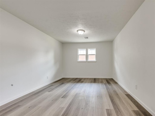 3044 S Madole Blvd, Oklahoma City, OK 73159 - empty room with wood finished floors and a textured ceiling