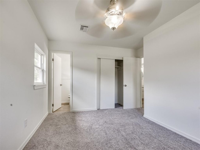 3044 S Madole Blvd, Oklahoma City, OK 73159 - unfurnished bedroom with carpet floors, a closet, connected bathroom, and a ceiling fan