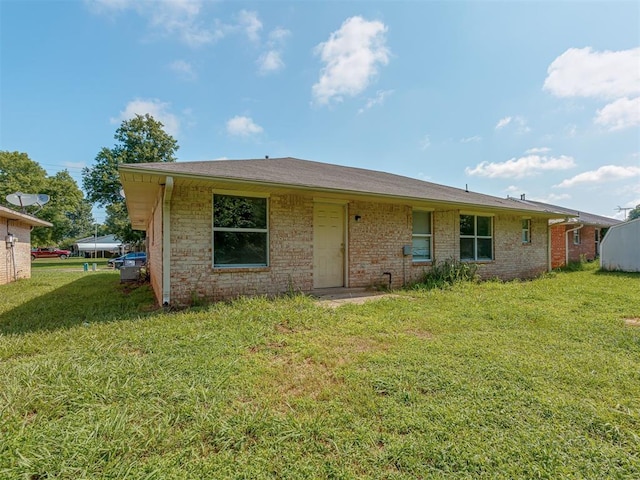 1106 Foggy Bottom Rd, Tecumseh, OK 74873 - back of property featuring a lawn and brick siding