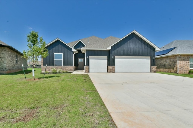 10617 Little Sallisaw Creek Dr, Yukon, OK 73099 - view of front facade with board and batten siding, concrete driveway, a front yard, and a garage