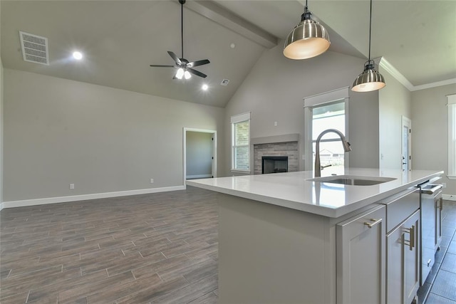 10617 Little Sallisaw Creek Dr, Yukon, OK 73099 - kitchen with open floor plan, ceiling fan, light countertops, a center island with sink, and high vaulted ceiling