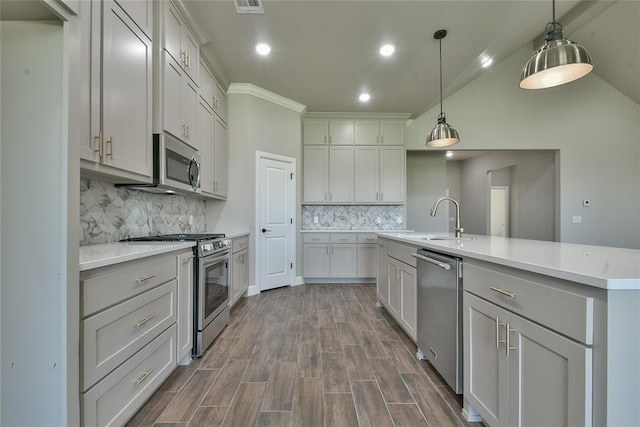 10617 Little Sallisaw Creek Dr, Yukon, OK 73099 - kitchen featuring stainless steel appliances, dark wood-style flooring, backsplash, light countertops, and decorative light fixtures