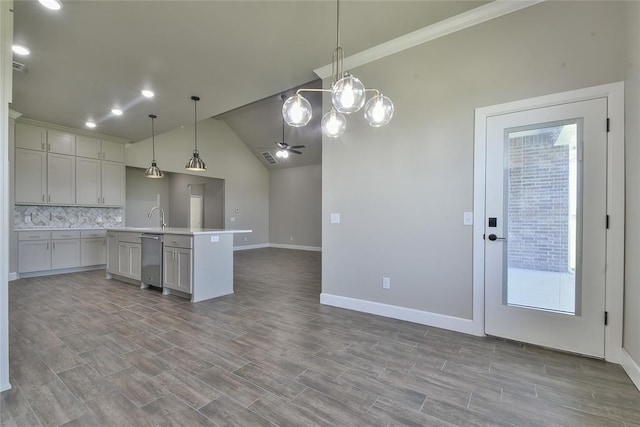 10617 Little Sallisaw Creek Dr, Yukon, OK 73099 - kitchen featuring open floor plan, backsplash, an island with sink, light countertops, and decorative light fixtures