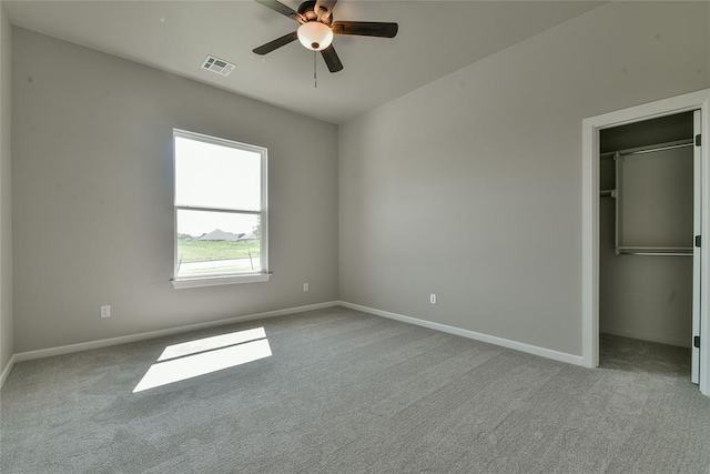 10617 Little Sallisaw Creek Dr, Yukon, OK 73099 - unfurnished bedroom featuring carpet floors, a spacious closet, and a ceiling fan