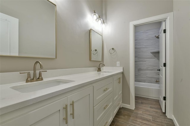 10617 Little Sallisaw Creek Dr, Yukon, OK 73099 - bathroom with double vanity, wood finished floors, and shower / tub combination