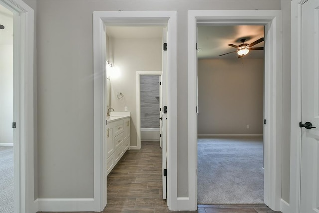 10617 Little Sallisaw Creek Dr, Yukon, OK 73099 - hallway featuring dark wood-style flooring and dark carpet