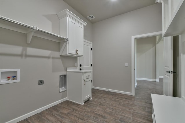 10617 Little Sallisaw Creek Dr, Yukon, OK 73099 - laundry room with hookup for an electric dryer, hookup for a washing machine, dark wood-style flooring, and cabinet space