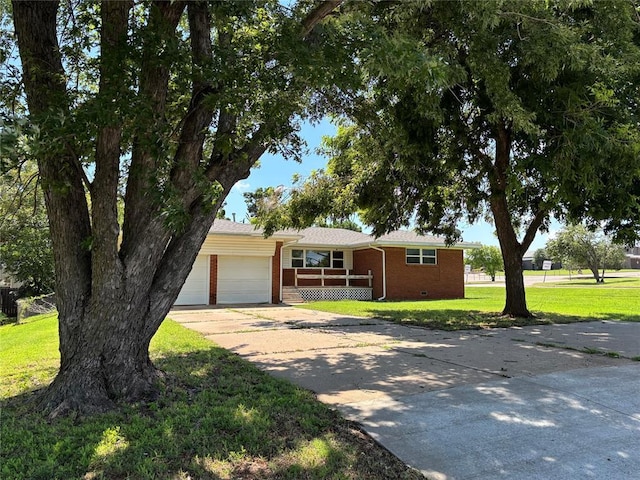 611 Garth Brooks Blvd, Yukon, OK 73099 - single story home with brick siding, concrete driveway, a garage, a front lawn, and a porch