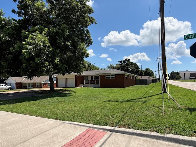 611 Garth Brooks Blvd, Yukon, OK 73099 - view of front facade featuring an attached garage, a front yard, and driveway
