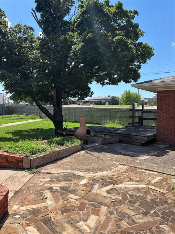 611 Garth Brooks Blvd, Yukon, OK 73099 - fenced backyard with a patio area and a deck