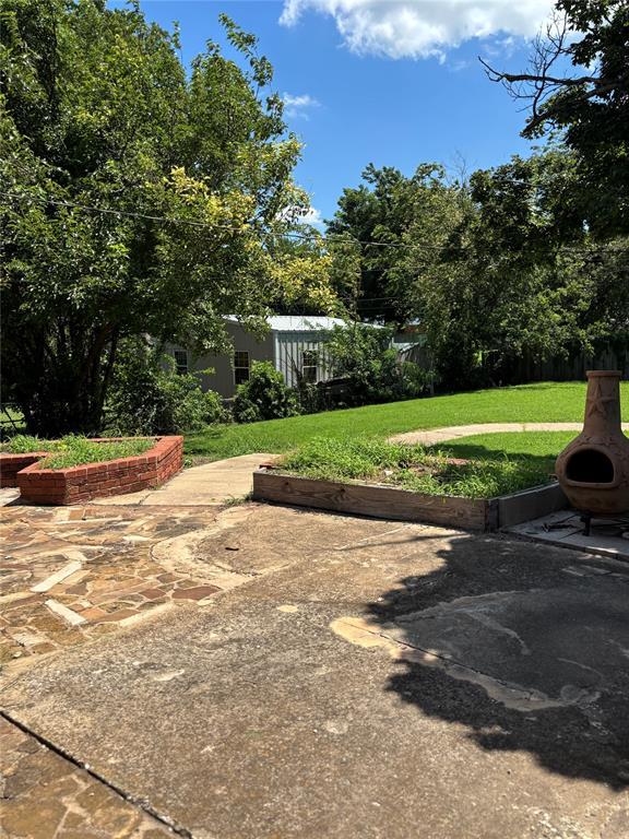 611 Garth Brooks Blvd, Yukon, OK 73099 - view of green lawn featuring a patio
