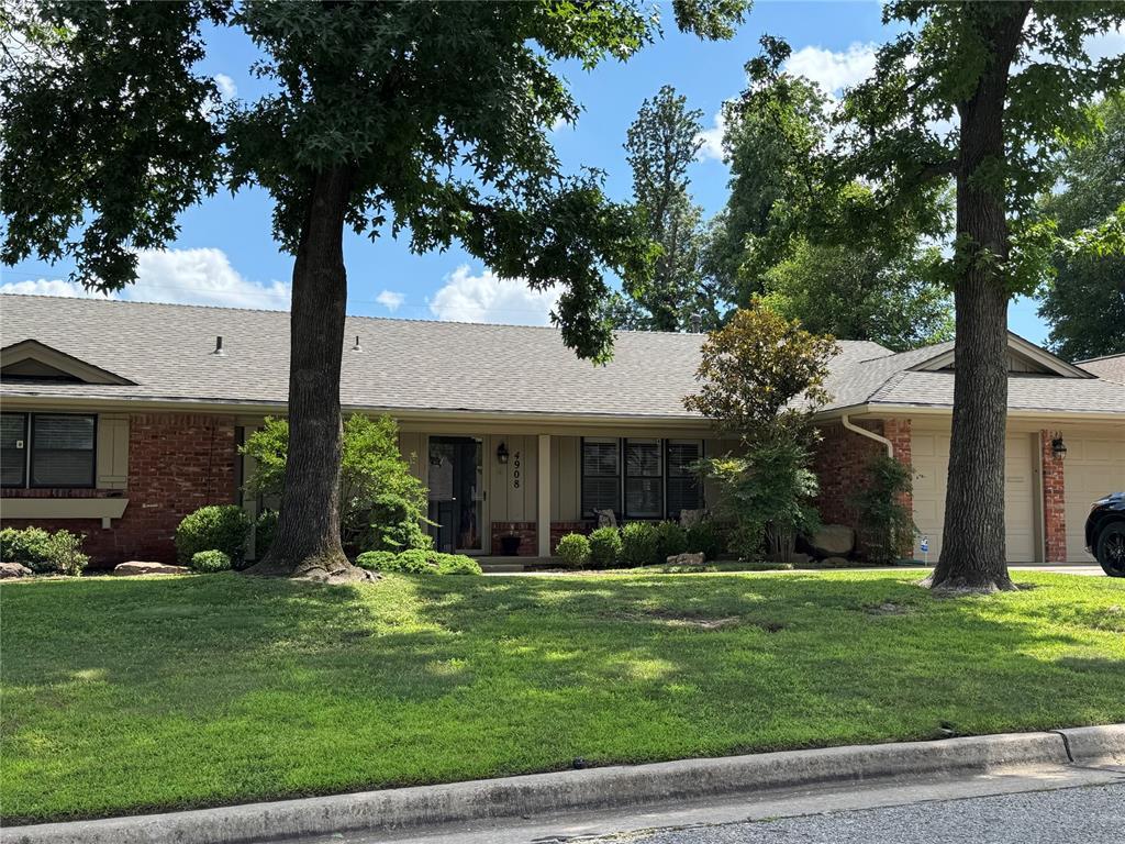 4908 NW 32nd St, Oklahoma City, OK 73122 - single story home featuring an attached garage, brick siding, a front lawn, and roof with shingles