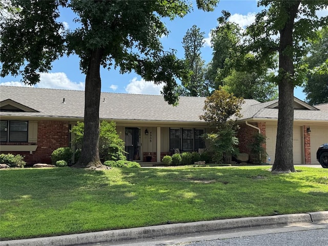 4908 NW 32nd St, Oklahoma City, OK 73122 - single story home featuring an attached garage, brick siding, a front lawn, and roof with shingles