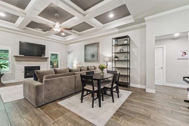 8040 Sweetgum St, Edmond, OK 73034 - dining area with a ceiling fan, wood finished floors, a fireplace, beamed ceiling, and ornamental molding