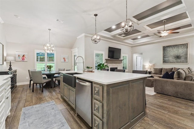 8040 Sweetgum St, Edmond, OK 73034 - kitchen featuring dishwasher, a chandelier, a fireplace, open floor plan, and crown molding