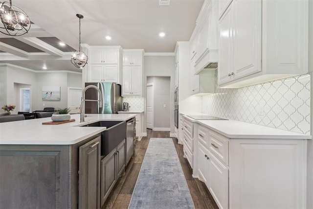 8040 Sweetgum St, Edmond, OK 73034 - kitchen with a chandelier, appliances with stainless steel finishes, white cabinetry, ornamental molding, and dark wood-style flooring