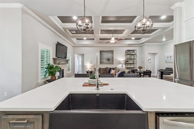 8040 Sweetgum St, Edmond, OK 73034 - kitchen featuring a chandelier, open floor plan, light countertops, ceiling fan, and coffered ceiling