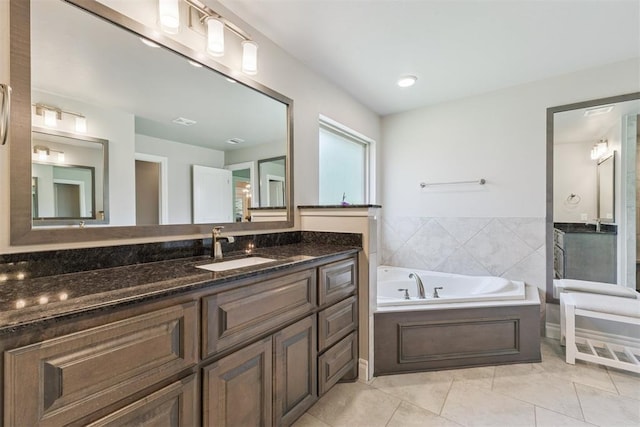8040 Sweetgum St, Edmond, OK 73034 - full bath with vanity, a garden tub, and tile patterned flooring