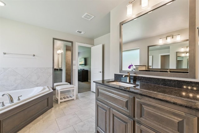 8040 Sweetgum St, Edmond, OK 73034 - full bath with vanity, a garden tub, and tile patterned floors