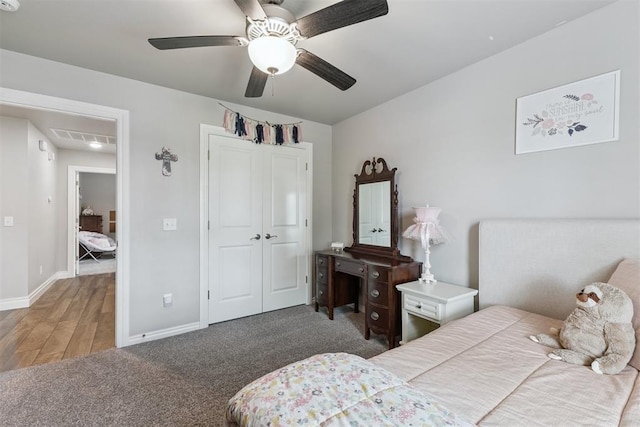 8040 Sweetgum St, Edmond, OK 73034 - bedroom with a closet, ceiling fan, wood finished floors, and carpet flooring