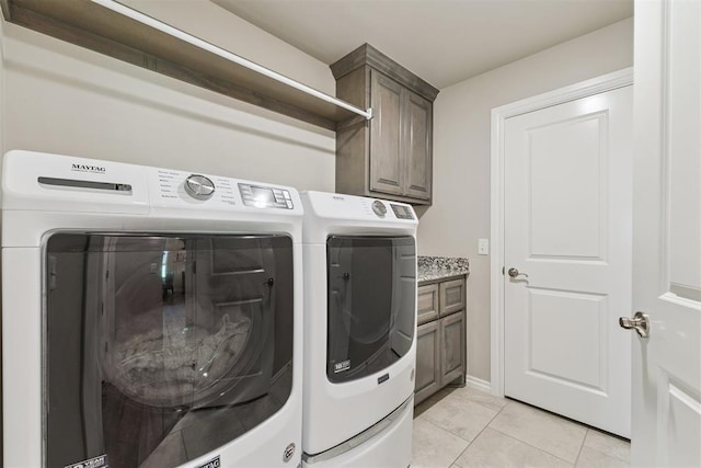 8040 Sweetgum St, Edmond, OK 73034 - laundry room featuring washer and clothes dryer, cabinet space, and light tile patterned floors
