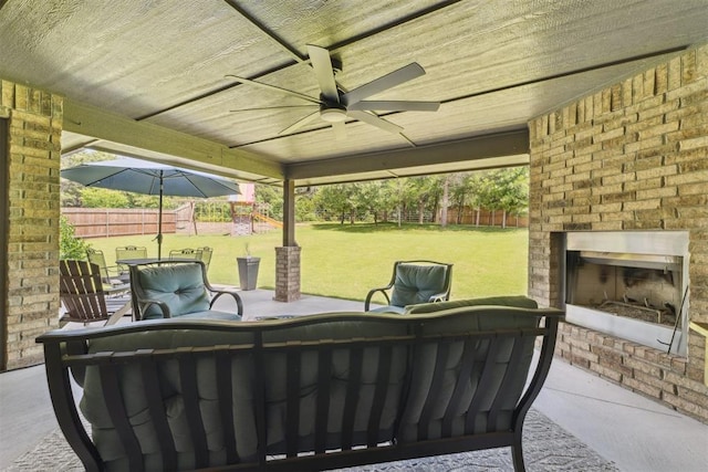 8040 Sweetgum St, Edmond, OK 73034 - fenced backyard with an outdoor brick fireplace, a patio area, and a ceiling fan